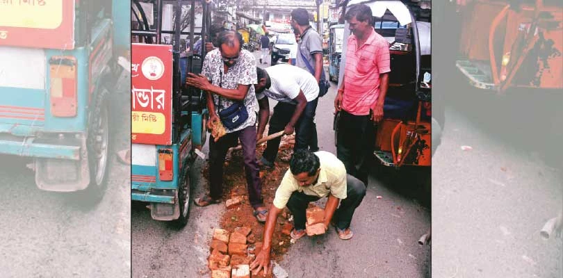 হুঁশ নেই বারাসত পুরসভার, বাধ্য  হয়ে রাস্তা ভরাট টোটোচালকদের